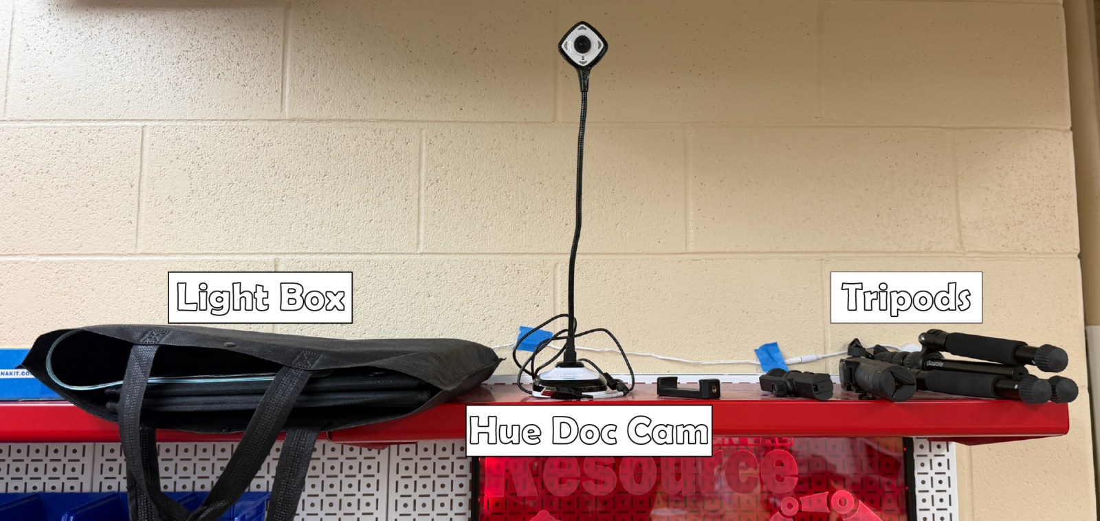 Light Box: The lightbox can be setup and used to take images that showcase smaller objects in a clean and well lit environment. This can be useful for presentations, posters, and reports.
Hue Doc Cam: The doc cam can be used as a way to take close-up images of small objects. The camera has a manual focus that is able to capture high fidelity images of objects on the scale of writing on a coin.
Tripods: The tripods can be setup to record a given design experiment or test from various angles.